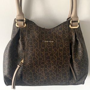 Brand new Calvin Klein tote. Classic, leather tote with many zipper compartments